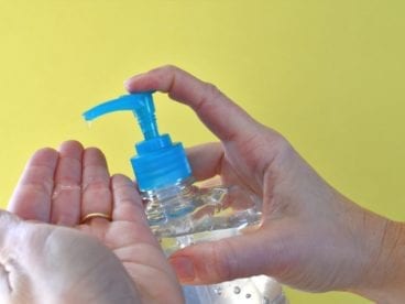 person applying hand sanitizer