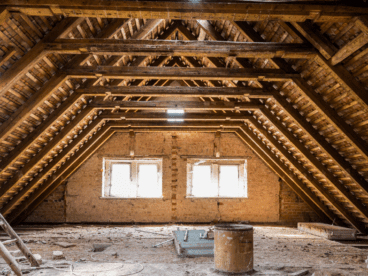 Bare attic with no insulation and 2 windows.